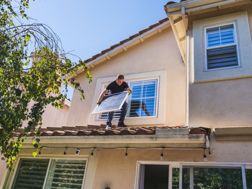 Worker on the roof of a house.