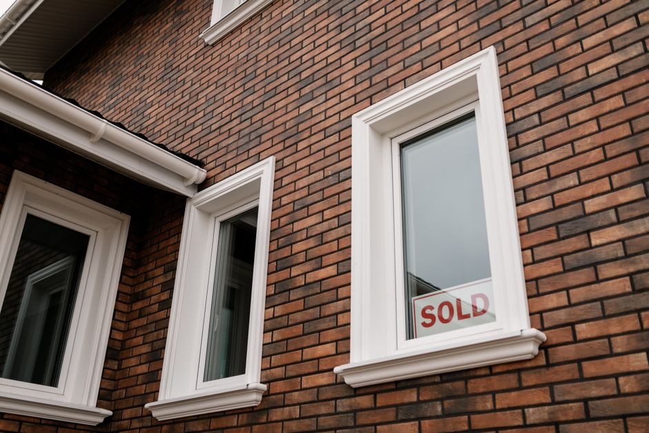 Brick house front with a window.